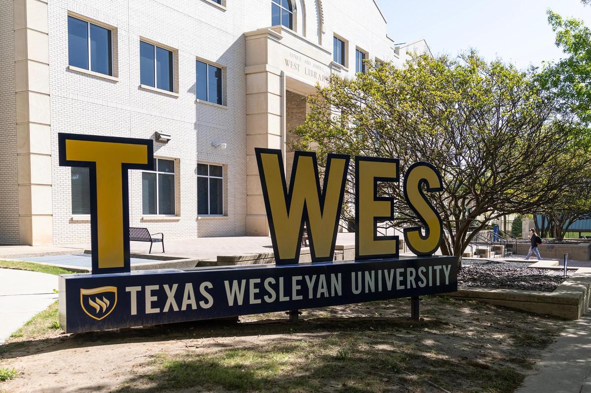 Students walk past the ’T Wes’ sign on the Texas Wesleyan University campus in Fort Worth on Tuesday, April 8, 2025.