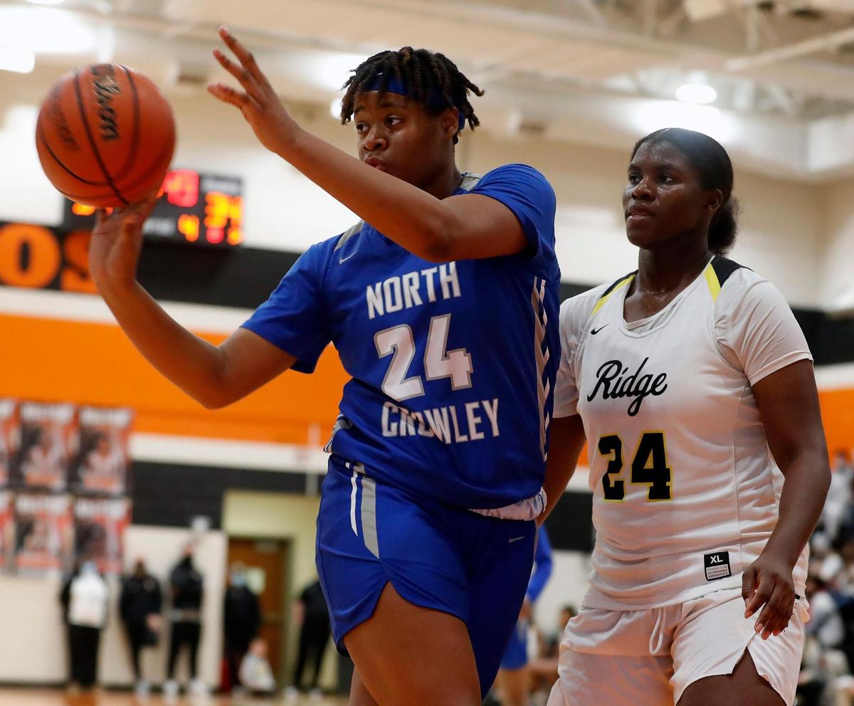 North Crowley center Amiya Hopkins (24) passes the ball away from Fossil Ridge’s Aaliyah Stephens (24) during the second half of a 6A Region 1 Bi-district girls basketball game at Haltom High School in Haltom City, Texas, Friday, Feb. 12, 2021. North Crowley defeated Fossil Ridge 44-41. (Special to the Star-Telegram Bob Booth)