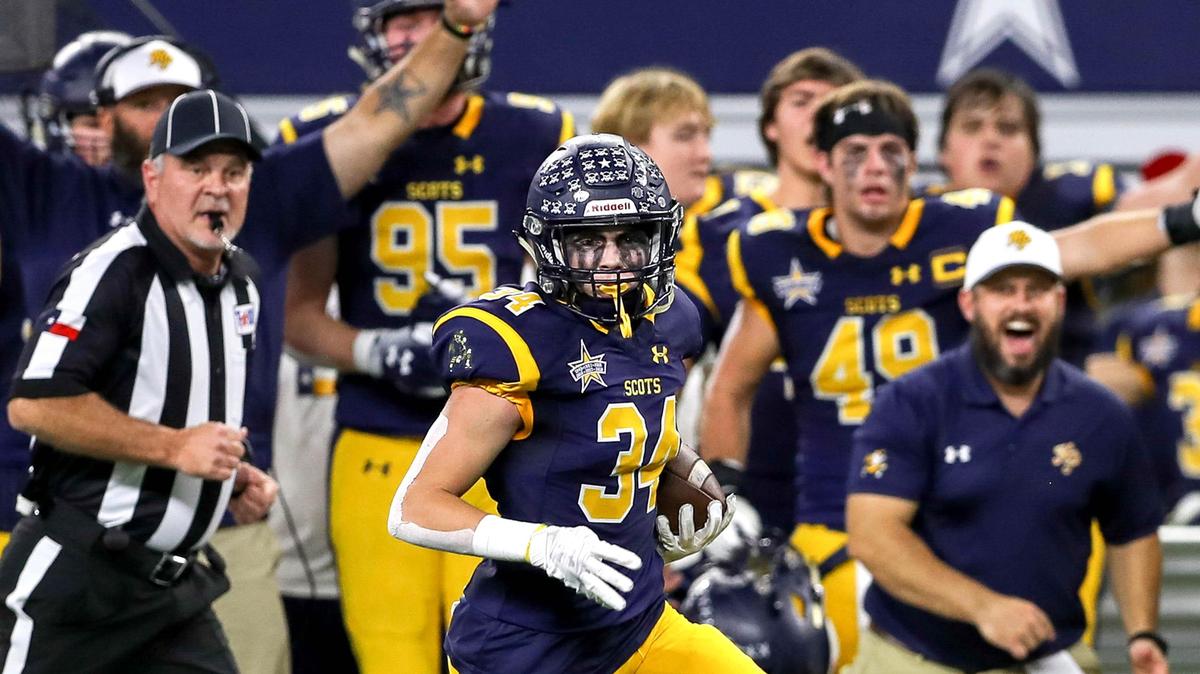 Highland Park defense back Tanner Schrank (34) returns an interception 34 yards for a touchdown against Magnolia during the first half of Thursday’s playoff game at AT&T Stadium in Arlington.