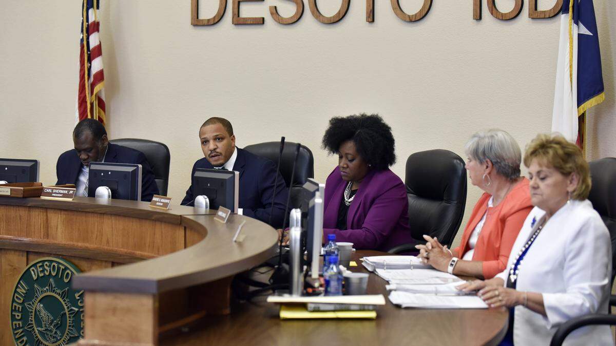 From 2017, Carl Sherman Jr., DeSoto ISD president, second from left, conducts a school board meeting to discuss the contract of DeSoto football head coach Todd Peterman.