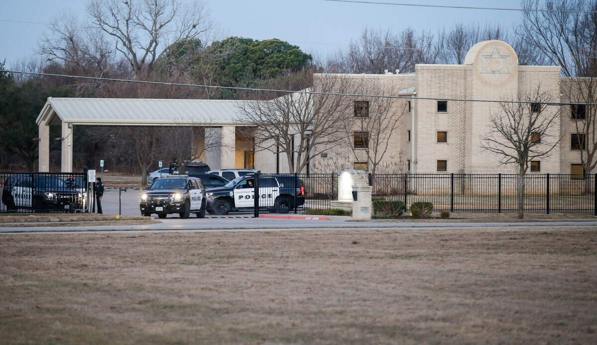 Police stand in front of the Congregation Beth Israel synagogue on Sunday in Colleyville. (AP Photo/Brandon Wade)