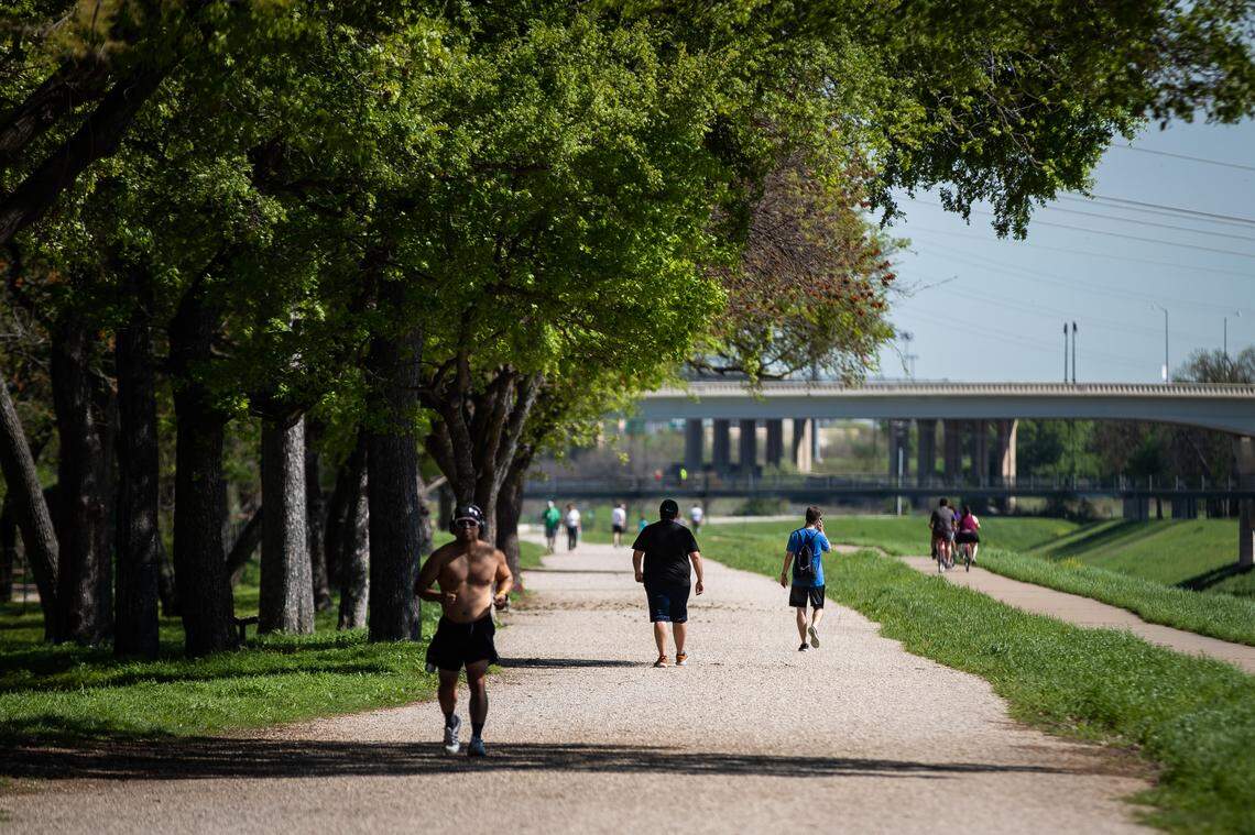 Residents exercise along the Trinity Trails during stay-at-home orders amid COVID-19 outbreak Wednesday, March 25, 2020, in Fort Worth. Residents are to stay home except for essential travel, but exercising outside is allowed.