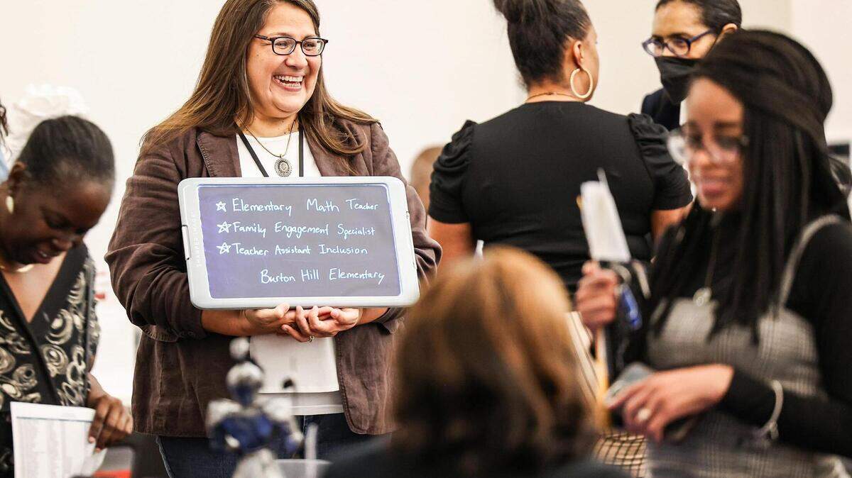 Juana Farias, an Instructional Coach at Burton Hills Elementary School, speaks with her colleagues during a Fort Worth Independent School District-wide teacher hiring fair in 2023.