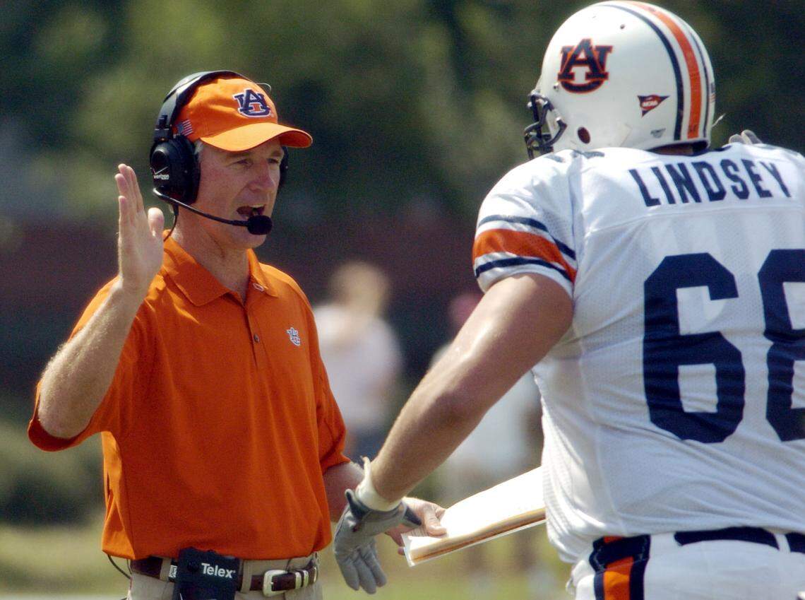 Auburn football coach Tommy Tuberville congratulates offensive guard Danny Lindsey (68) following a successful series of downs that led to a first quarter touchdown in Starkville, Miss., Saturday, Sept. 11, 2004. (AP Photo/Rogelio Solis)