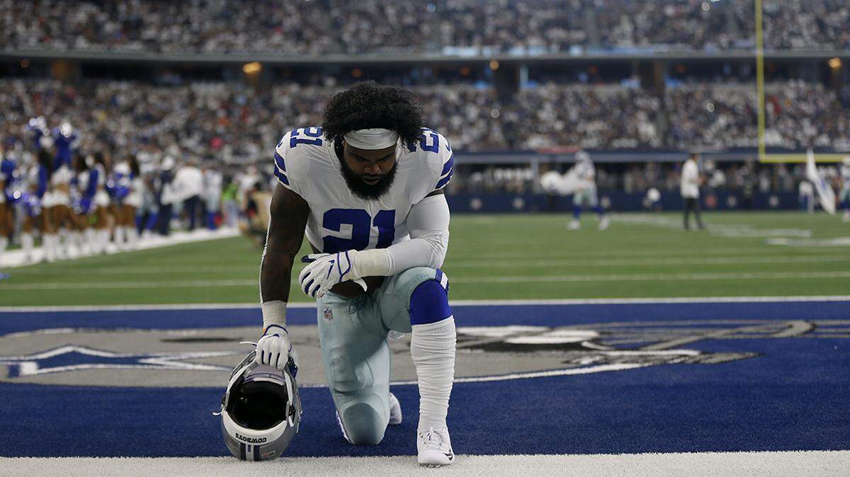 Dallas Cowboys running back Ezekiel Elliott (21) kneels in the end zone at the start of a NFL football game against the New York Giants in Arlington, Texas, Sunday, Sept. 8, 2019. (AP Photo/Ron Jenkins)