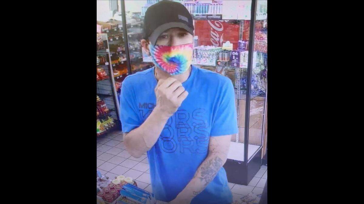 One suspect, armed with a handgun, has a tattoo on his left arm.