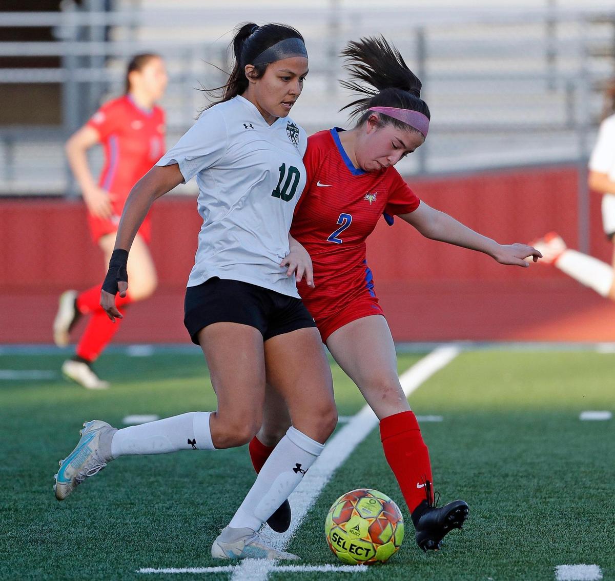 Kennedale’s Angelina Olmos (10) brings the ball down the pitch defended by Carter Riverside’s Mairely Galvan (2) during a 4A Region 1 bi-district girls soccer playoff game at Elk Stadium in Burleson, Texas, Friday, Mar. 25, 2022. Kennedale moves on after defeating Carter Riverside 5-1. (Special to the Star-Telegram Bob Booth)