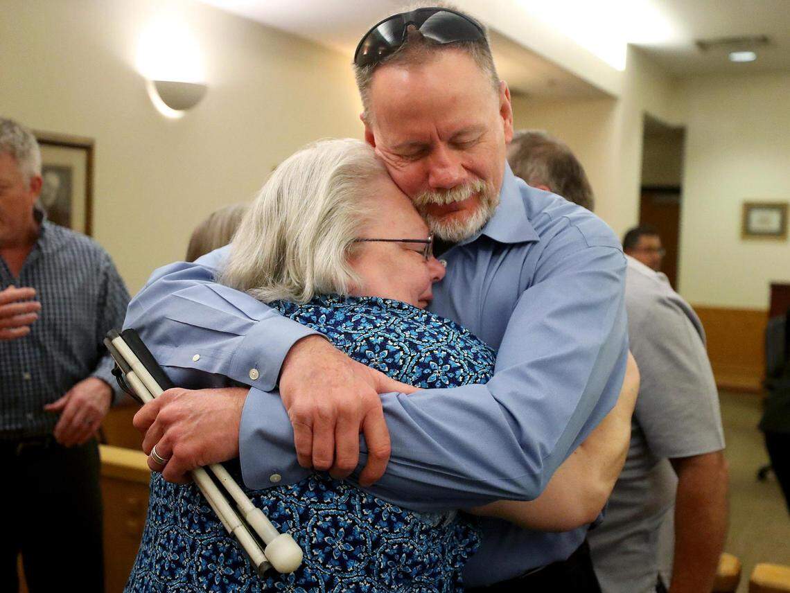 Jim Walker, right, hugs Kathleen Barnett after Glen McCurley was sentenced to life in prison for the murder of his sister, Carla Walker, on Tuesday, August 24 2021. McCurley has originally pleaded not guilty but changed his plea to guilty.