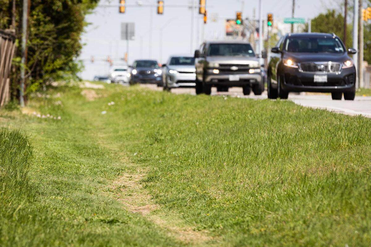 A path in the grass is used by pedestrians along West Bailey Boswell Road near Wind River Drive in Fort Worth.