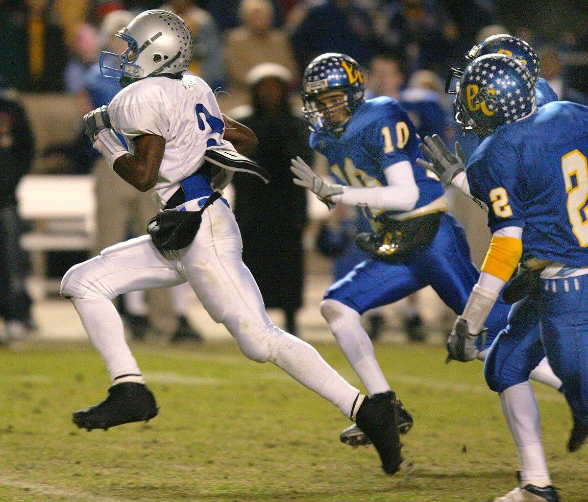 North Crowley quarterback Lance Moss (left) breaks away from a number of Bay City defenders, including Chris Hicks,#10, to score in the 3rd quarter. North Crowley wins 20-6. North Crowley High vs Bay City High for the 4A Division 1 state title at Kyle Field in College Station, Texas, Saturday, December 13, 2003. (Star-Telegram/Ron Jenkins)