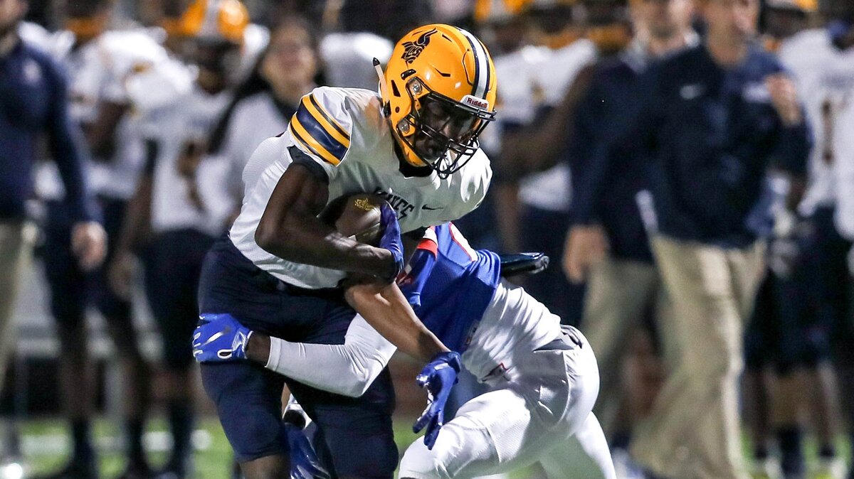 Arlington Lamar wide receiver Isaiah Neyor (5) tries to break a tackle from Duncanville defensive back Stacy Brown during the first half, Friday night, November 30, 2018 in the 6A Division I regional playoff game played at Newsom Stadium in Mansfield, TX.