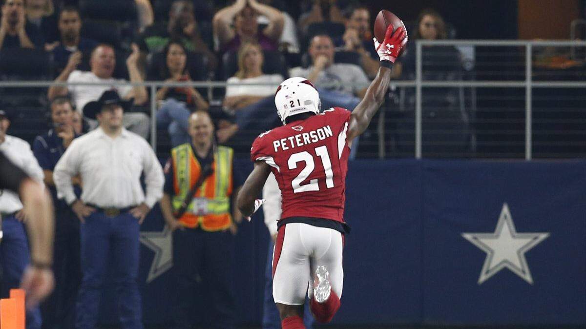 Arizona Cardinals defensive back Patrick Peterson (21) runs for a touchdown after an interception off Dallas Cowboys quarterback Cooper Rush during the first half of a preseason NFL football game, Sunday, August 26, 2018, at AT&T Stadium in Arlington, Texas.