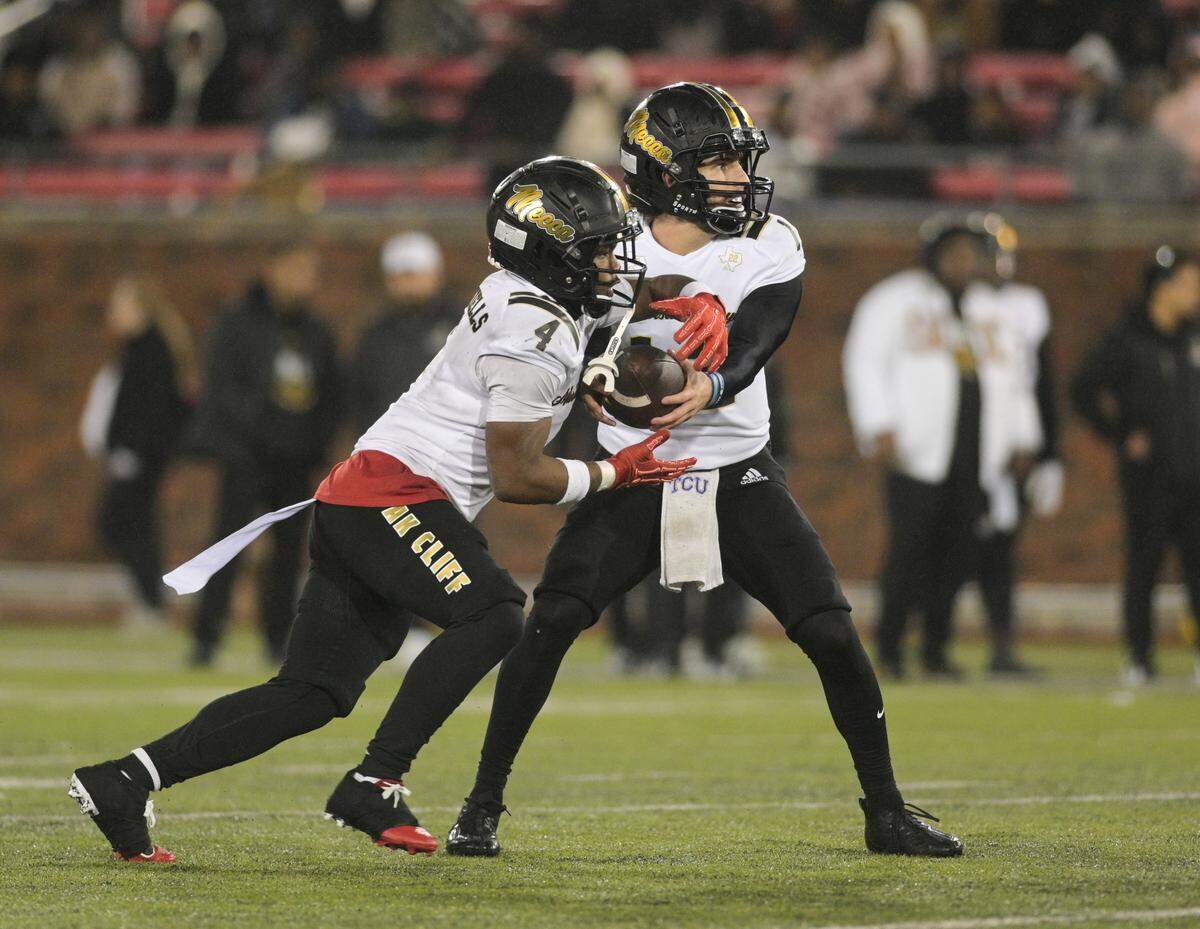 South Oak Cliff quarterback Carter Kopecky (12) hands the ball off to running back Levon Morton (4) against Argyle during a Class 5A Division II state semifinal on Friday, Dec. 13, 2024 at Gerald J. Ford Stadium in University Park, Texas.