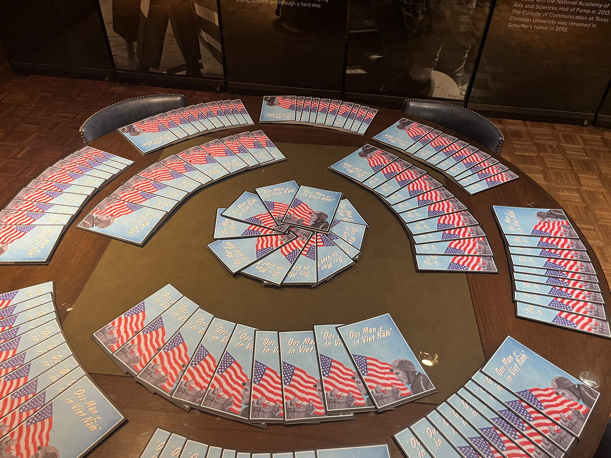 Brochures lined a table at the celebration of legendary journalist Bob Schieffer’s new UT Arlington exhibit showcasing photos he took during the Vietnam War for the Fort Worth Star-Telegram.