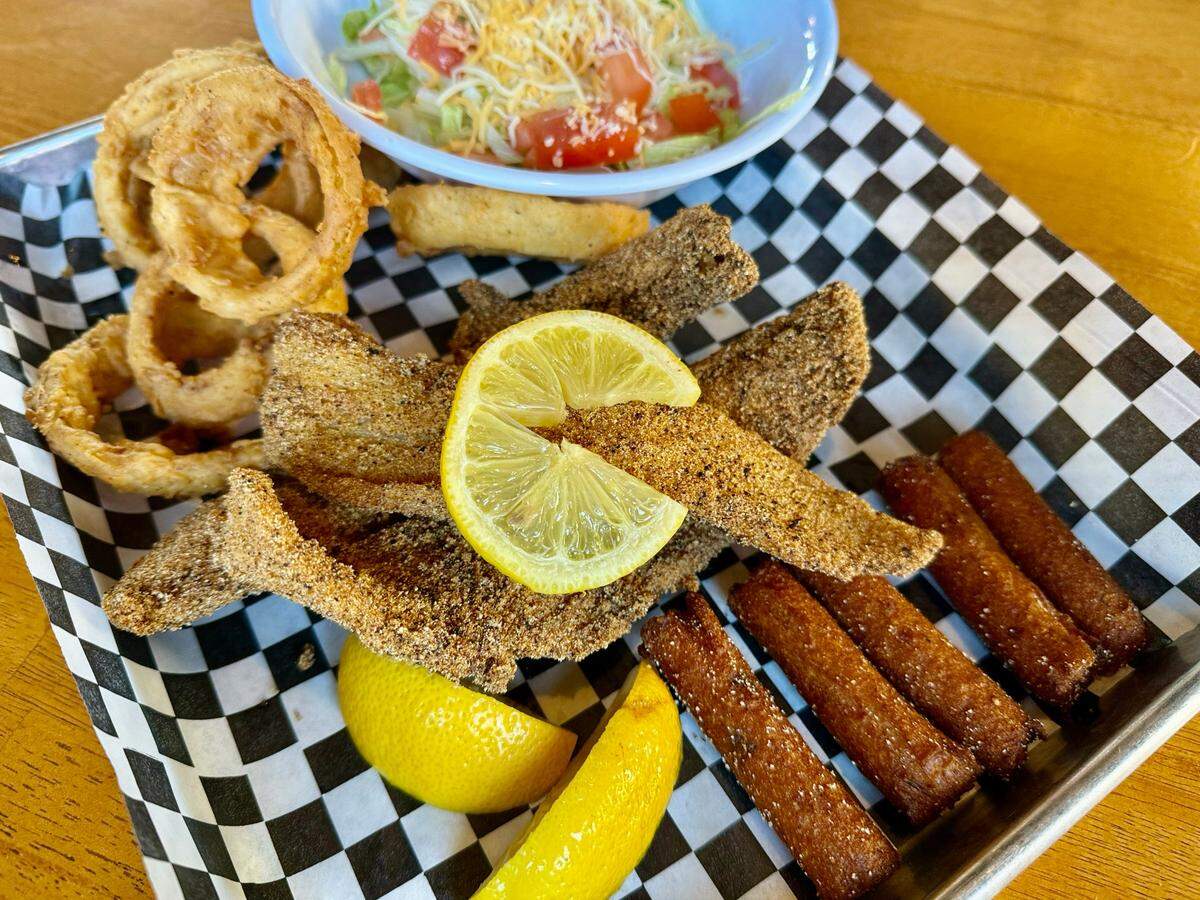 A fried catfish platter with hush puppies, onion rings and a side salad at The Point on Lake Worth restaurant Oct. 12, 2024.