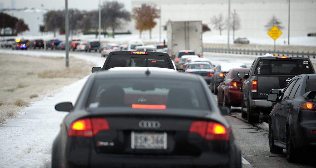 Traffic backs up on the ice-covered ramp from Airport Freeway to the south entrance to Dallas-Fort Worth International Airport on Friday, Dec. 6, 2013.