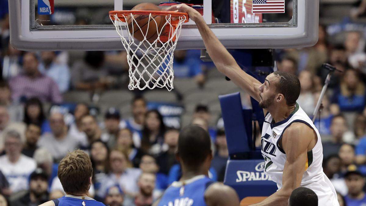 Utah Jazz center Rudy Gobert dunks in front of a trio of Dallas Mavericks in the first half of Thursday's game in Dallas. Utah won 119-112.