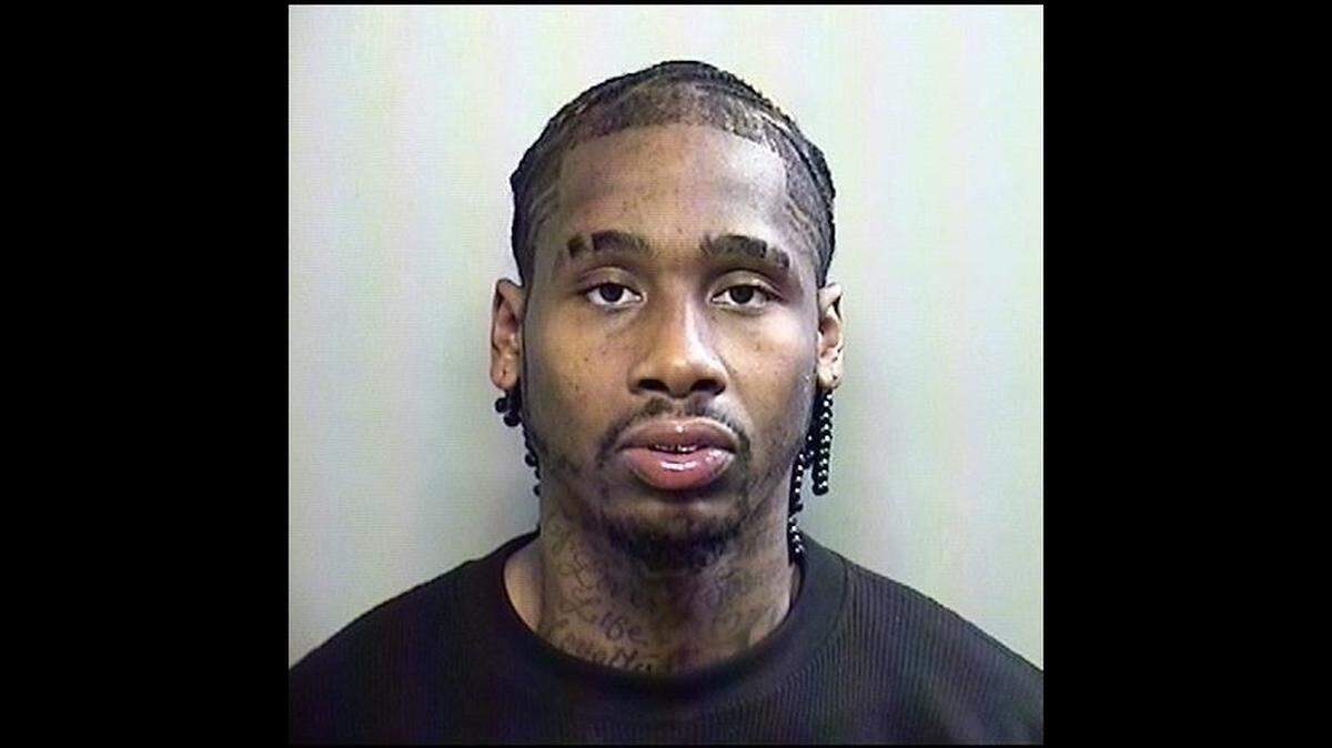 Lonnie Johnson, a man suspected of backing into a police officer’s motorcycle, was in jail Saturday facing an aggravated assault against a public servant charge.