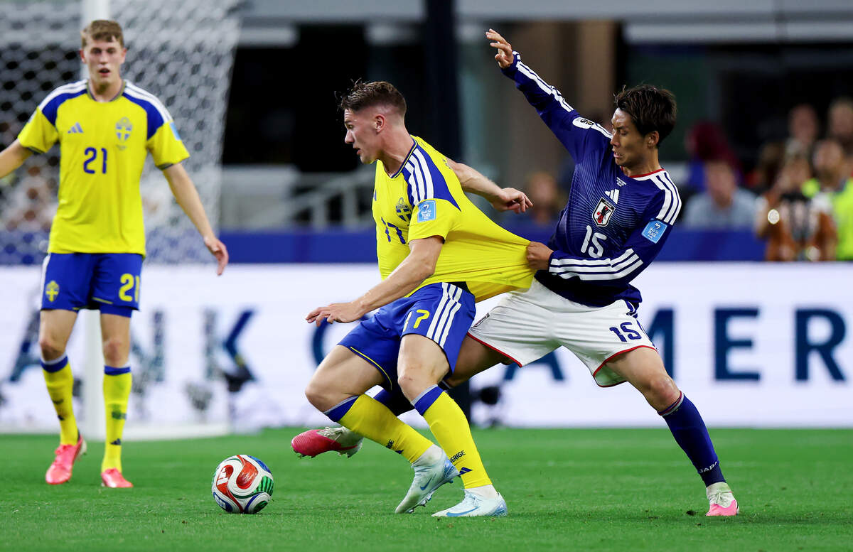 Sweden forward Viktor Gyokeres and Japan midfielder Daichi Kamada battle for the ball during the first half of a FIFA World Cup 2026 group stage match on Thursday, June 25, 2026, at Dallas Stadium in Arlington.