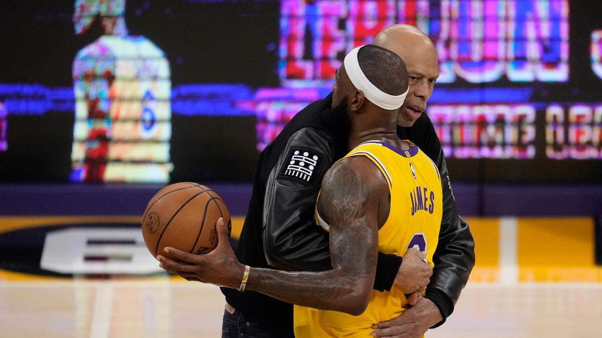 Kareem Abdul-Jabbar, left, hugs Los Angeles Lakers forward LeBron James after passing Abdul-Jabbar to become the NBA’s all-time leading scorer during the second half of an NBA basketball game against the Oklahoma City Thunder Tuesday, Feb. 7, 2023, in Los Angeles.