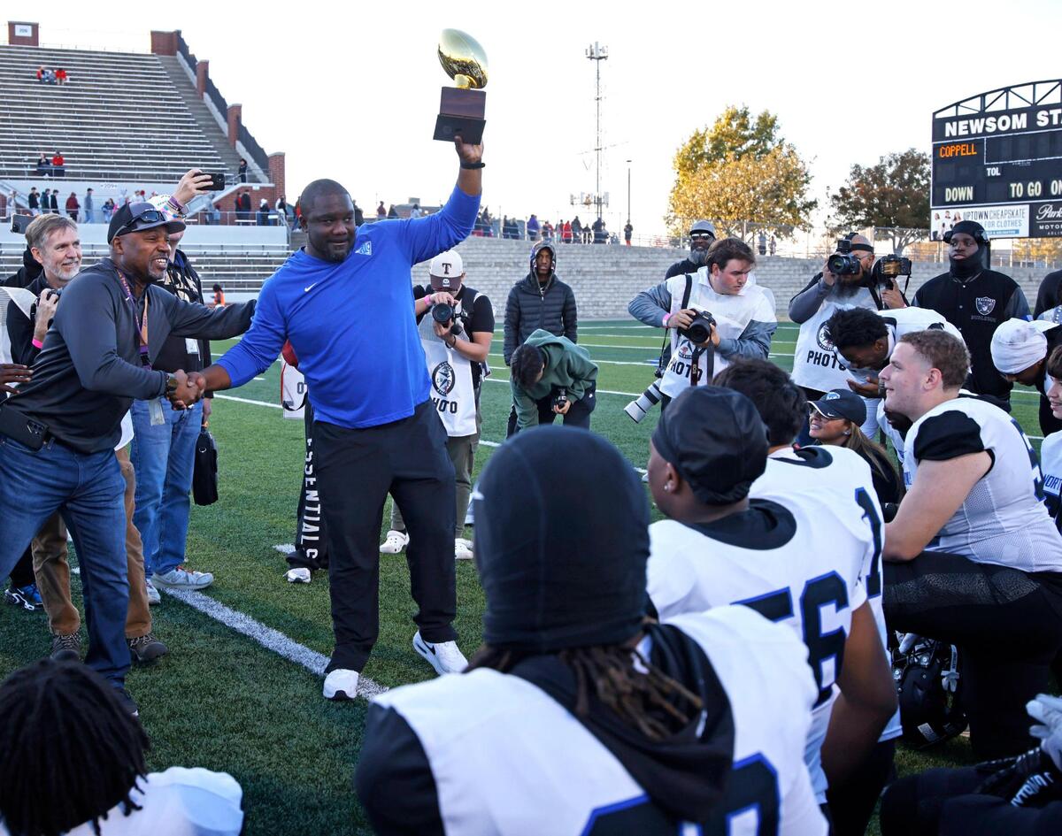 North Crowley head coach Ray Gates receives the trophy after winning the UIL District 6A D1 Regional football game at Vernon Newsom Stadium in Mansfield, Texas, Saturday, Nov. 30, 2024.