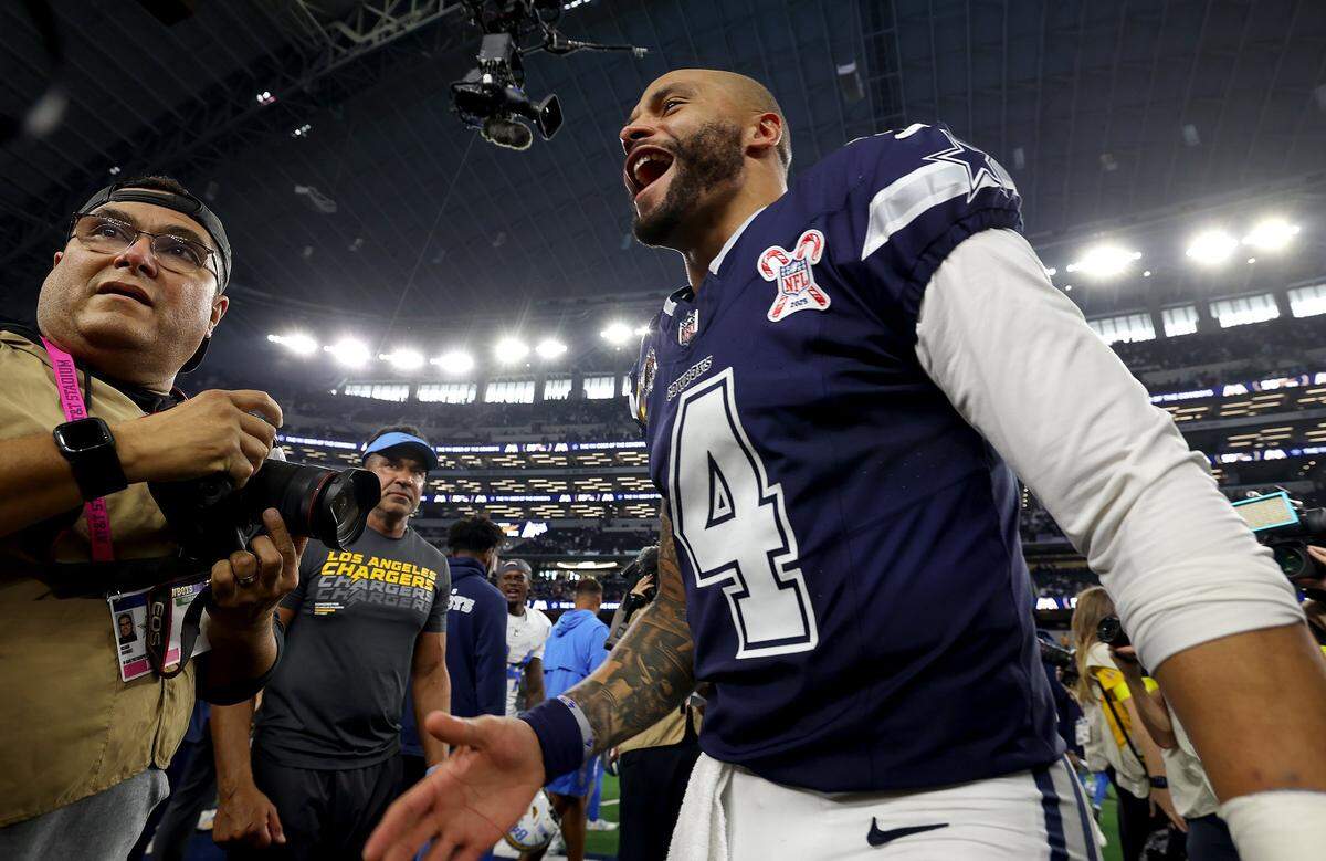 Dallas Cowboys quarterback Dak Prescott smiles after seeing Los Angeles Chargers quarterback Trey Lance, previously of the Dallas Cowboys, on Sunday, Dec. 21, 2025, at AT&T Stadium.