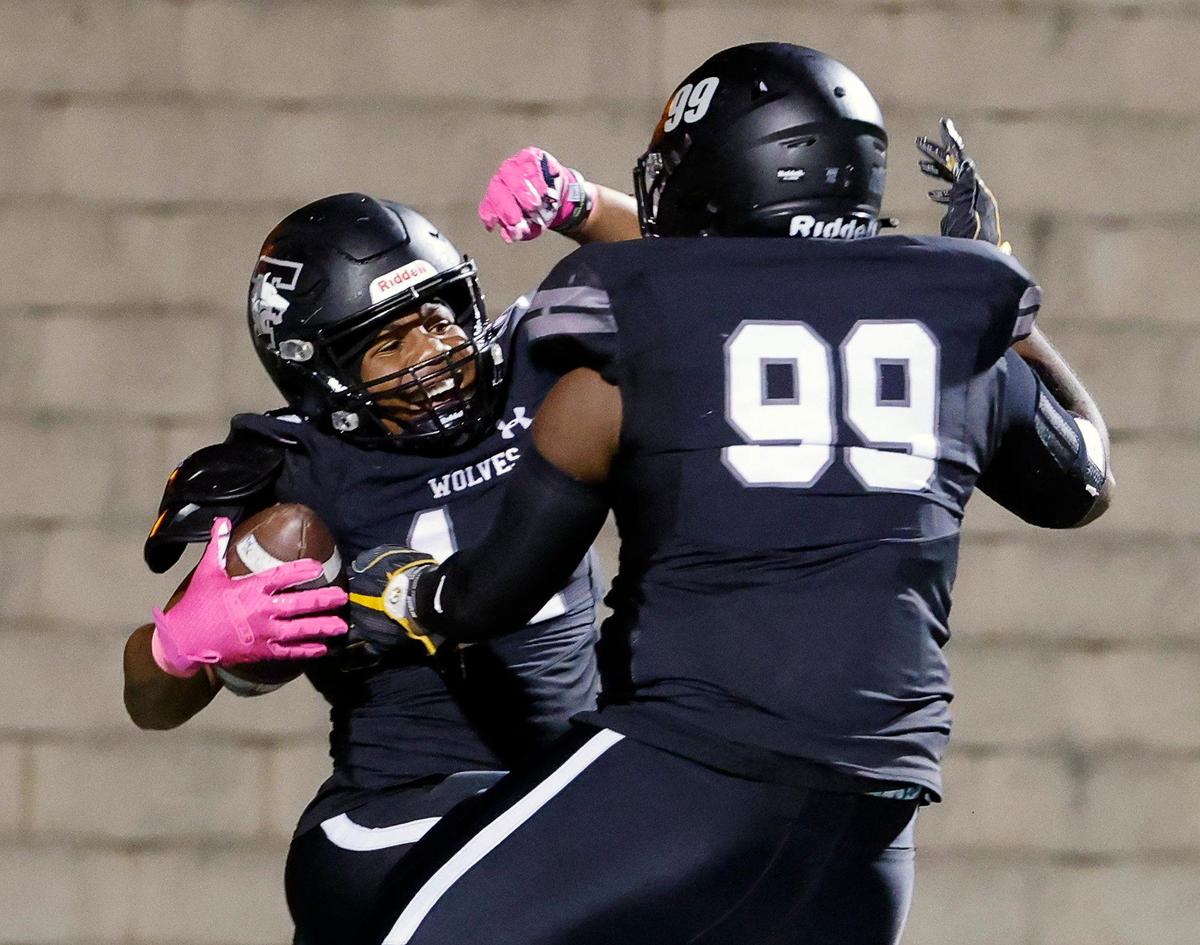 Timberview linebacker Sean Larry (14) celebrates with defensive lineman Dilan Battle (99) after his fumble recovery in the first half of a UIL football game at Vernon Newsom Stadium in Mansfield, Texas, Thursday, Oct. 19, 2023. Timberview led 63-0 at the half.