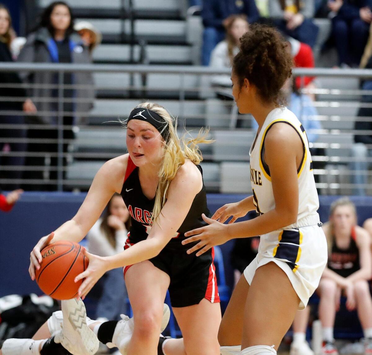 Argyle’s Caroline Lyles grabs a loose ball in front of Stephenville’s Mya Wilson during a high school 4A Region 1 Area Round playoff basketball game at Weatherford High School in Weatherford, Texas, Thursday, Feb. 11, 2022. Argyle defeated Stephenville 56-41. (Special to the Star-Telegram Bob Booth)