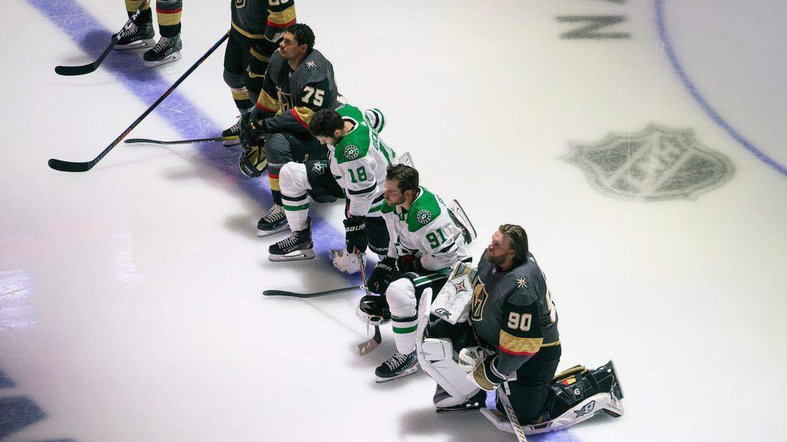 Dallas Stars’ Jason Dickinson (18), Tyler Seguin (91) and Vegas Golden Knights’ Ryan Reaves (75) and goalie Robin Lehner (90) take a knee for Black Lives Matter during the national anthem prior to an NHL hockey playoff game Monday, Aug. 3, 2020 in Edmonton, Alberta.