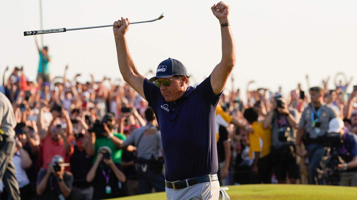 Phil Mickelson celebrates his victory in the PGA Championship on Sunday at age 50, becoming the oldest player to win a major tournament.
