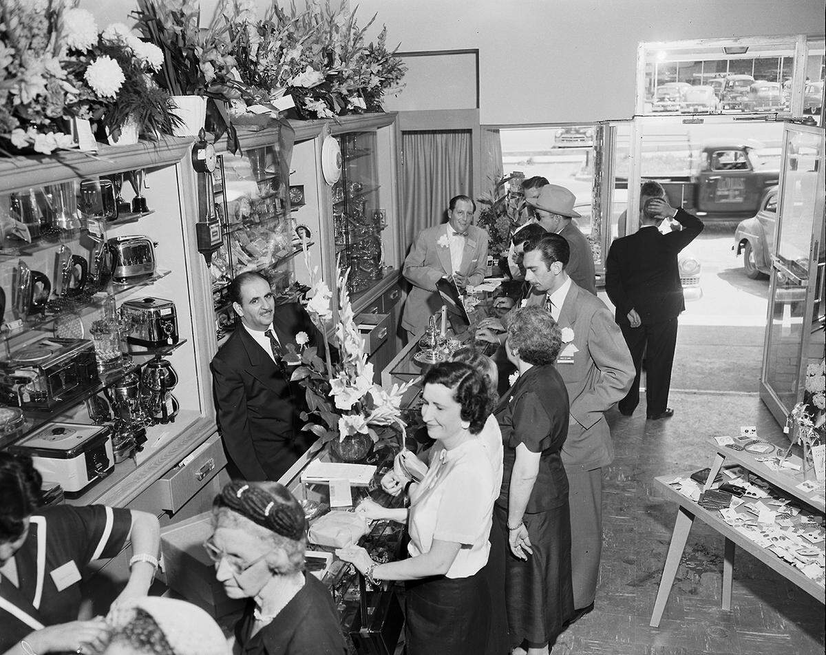 May 1, 1952: Customers inspect counter displays as Goldstein Brothers open their new store at 2608 W. Berry St. in Fort Worth. At left, behind counter, is Bernard Goldman, manager of the store. Also shown, standing behind the counter, Dore Goldstein, one of the owners.