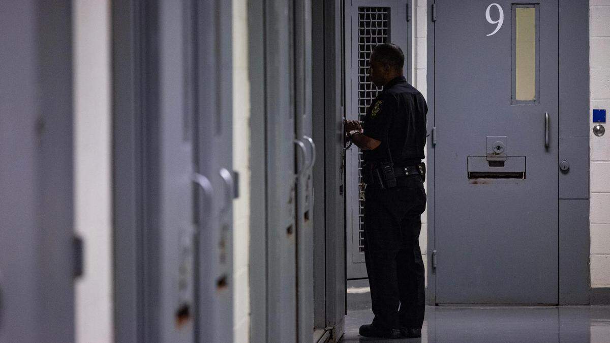 A correctional officer checks on inmates at the Tarrant County Corrections Center in Fort Worth on Thursday, Jan. 25, 2024.