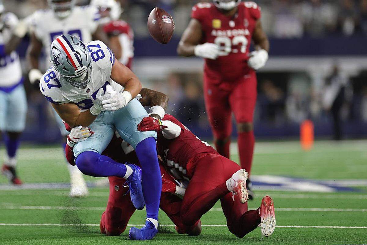 ARLINGTON, TEXAS - NOVEMBER 03: Jake Ferguson #87 of the Dallas Cowboys fumbles the ball ahead of Garrett Williams of the Arizona Cardinals during the second quarter in the game at AT&T Stadium on November 03, 2025 in Arlington, Texas. (Photo by Stacy Revere/Getty Images)