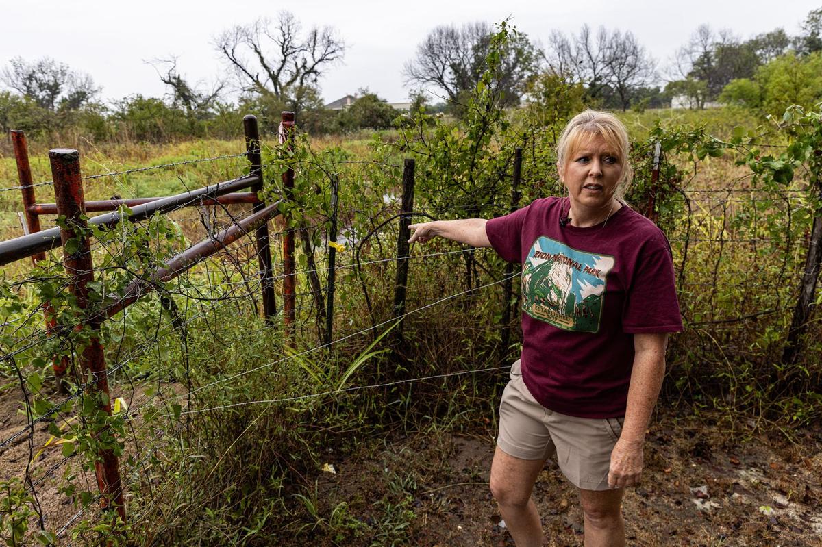 Springtown resident Cynthia Courtney points to the area where runoff streams into her backyard. Courtney has dealt with flooding since the D.R. Horton subdivision was built behind her property in 2023. According to Courtney, the construction has disrupted the natural drainage pattern and has since caused substantial flooding in and around her home.