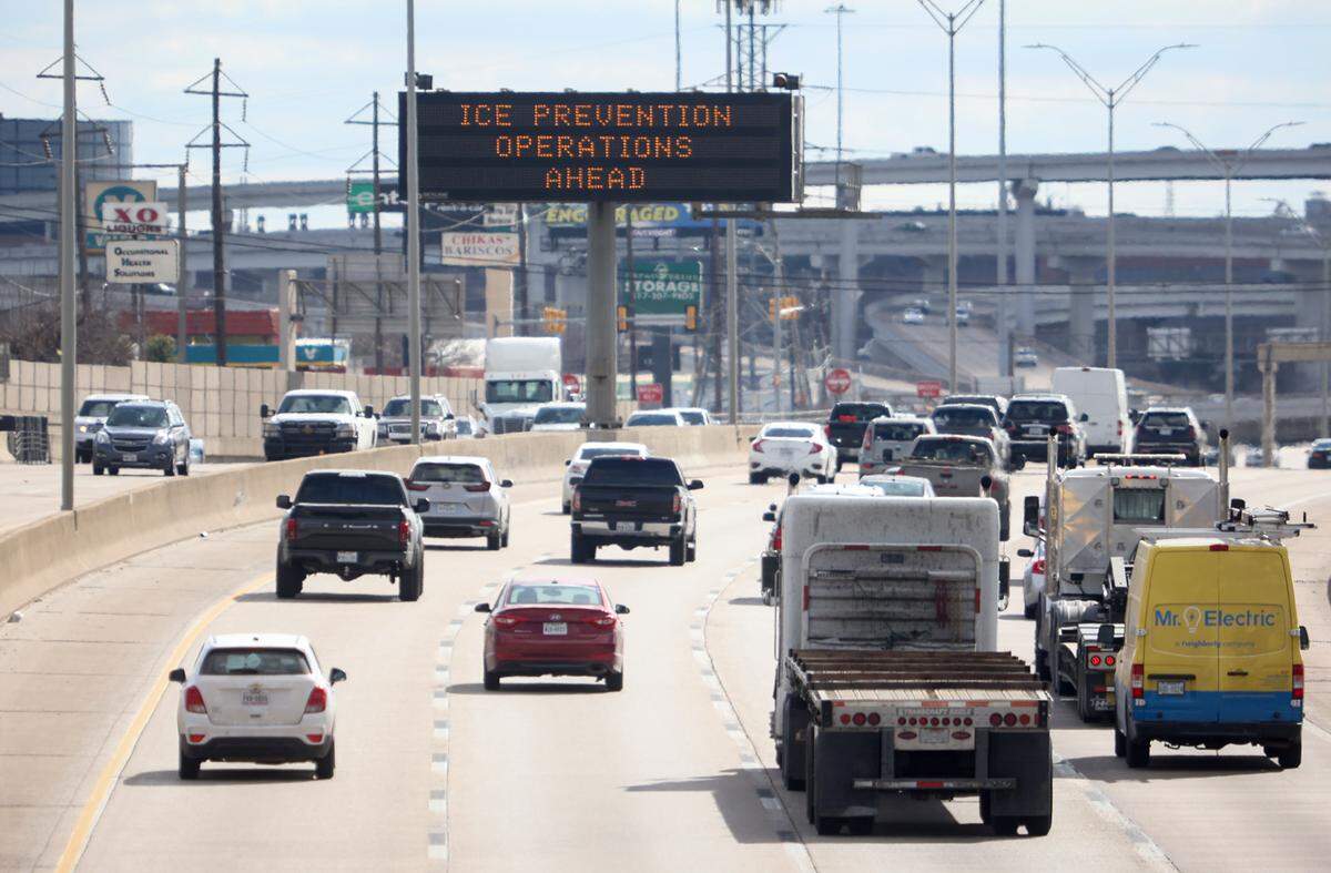A sign cautions drivers of the possibility of work crews preparing I-35W near the Seminary Drive exit for winter weather conditions on Tuesday, February 1, 2022. North Texas will be under a winter storm watch from Wednesday at 6 p.m. until Thursday at 6 p.m.