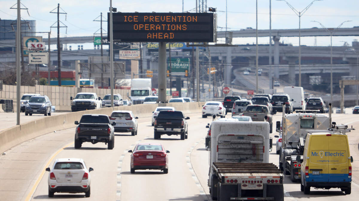 A sign cautions drivers of the possibility of work crews preparing I-35W near the Seminary Drive exit for winter weather conditions on Tuesday, February 1, 2022. North Texas will be under a winter storm watch from Wednesday at 6 p.m. until Thursday at 6 p.m.