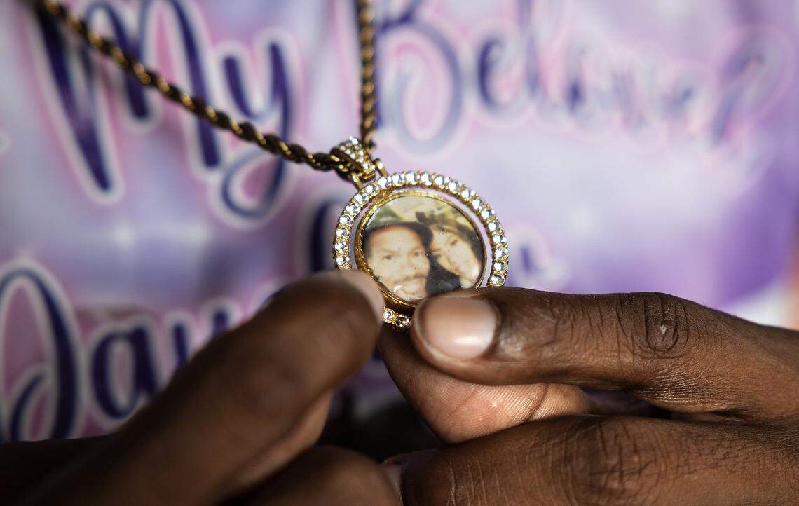 Antonio Harris shows a locket with a picture with his daughter, Tonishea Harris, while talking about her on Wednesday, Nov. 19, 2025. Tonishea Harris, 36, and her unborn child died from a gunshot wound on Oct. 21.