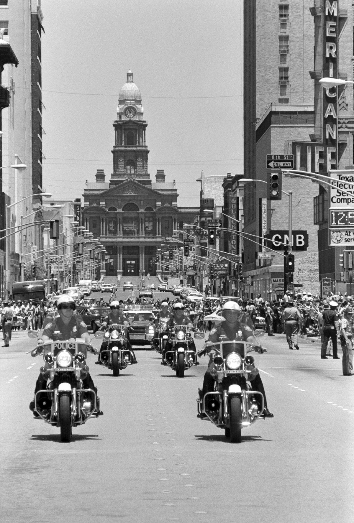 President Jimmy Carter’s motorcade with Fort Worth police in downtown Fort Worth during his visit on June 23, 1978. The Tarrant County Courthouse is seen in the background.