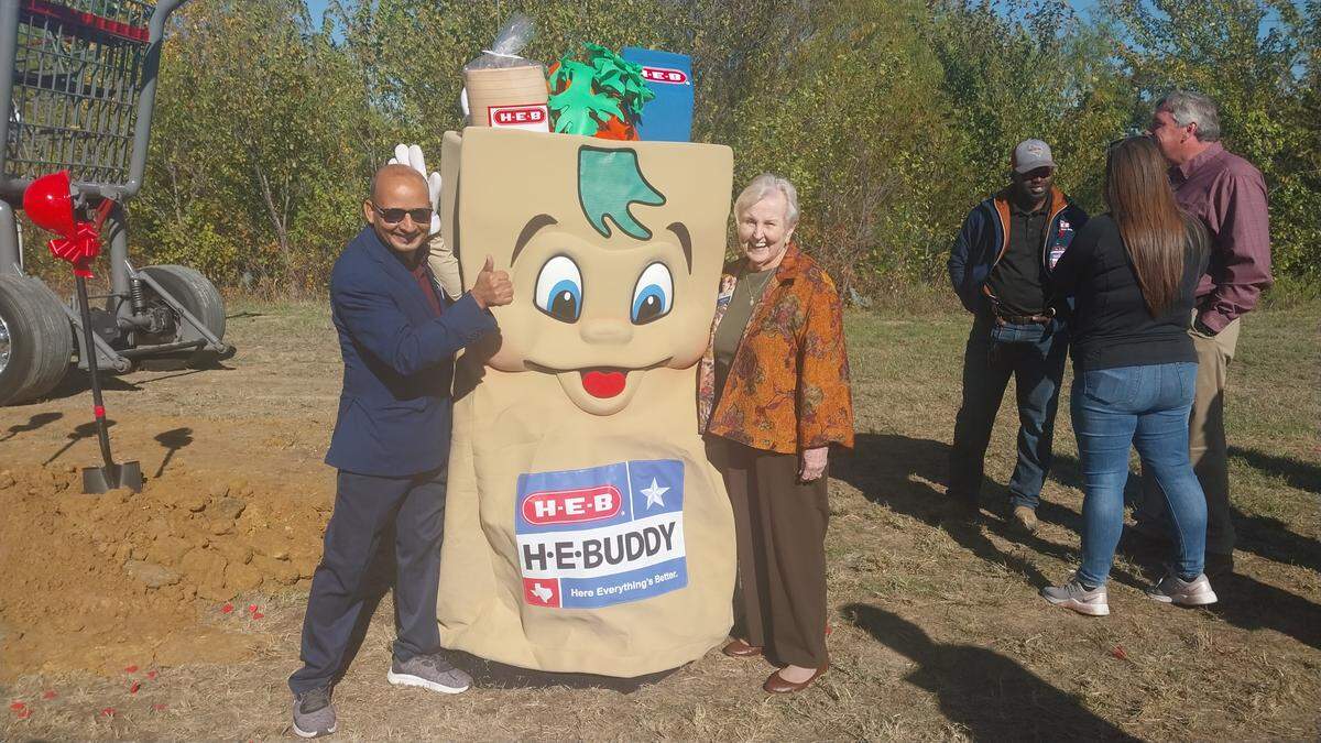 Euless Mayor Pro Tem Tika Paudel (left) and Mayor Linda Martin pose with mascot H-E-Buddy at the groundbreaking for Tarrant County’s third H-E-B location on Nov. 21, 2024.