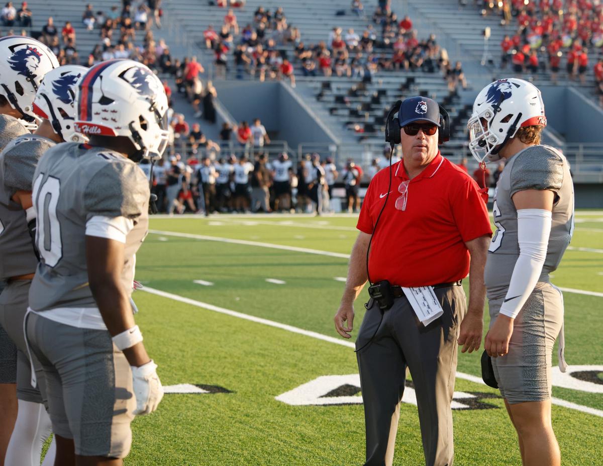 Richland head coach Ged Kates talks to players before a UIL football game at Birdville Fine Arts and Activity Center in North Richland Hills Friday, Sept. 6, 2004.