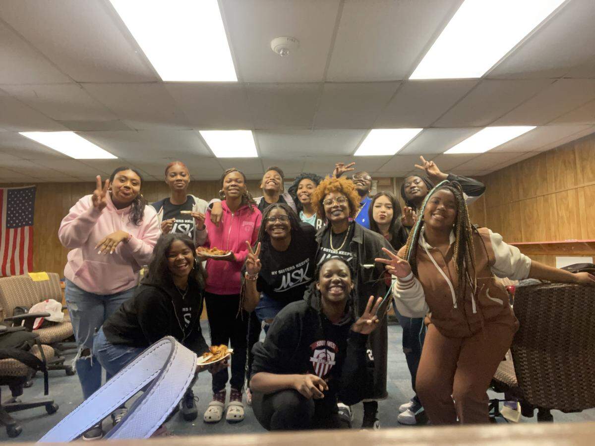 Southwest High School students who are in the My Sister’s Keeper program enjoy pizza at one of their weekly meetings.