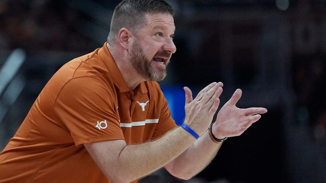 Texas head coach Chris Beard talks to his players during the first half of an NCAA college basketball game against Arkansas-Pine Bluff in Austin, Texas.