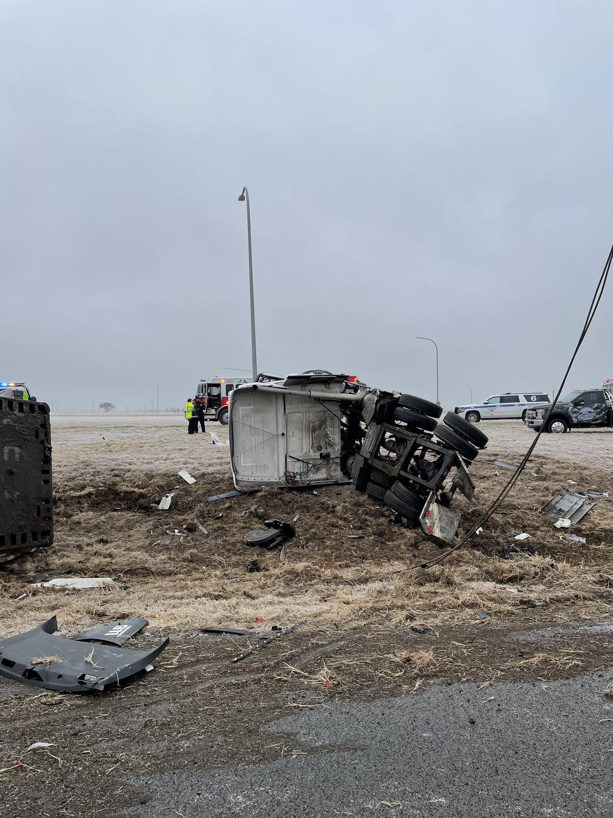 An 18-wheeler was split open after a crash near Texas Motor Speedway and Roanoke, officials said. Two Northlake police officers were involved in the accident and were among four people injured.