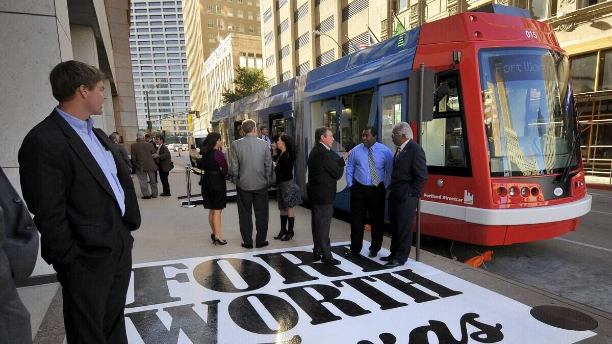 A red streetcar on a city street in 2010