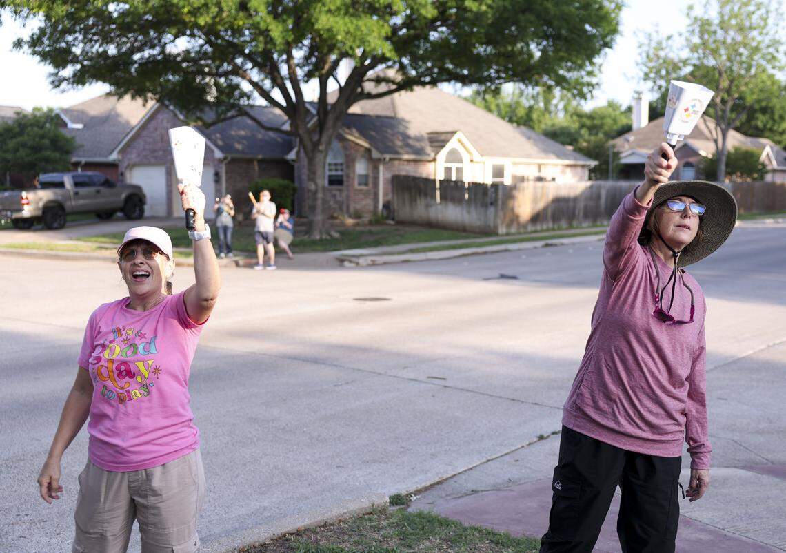 Park Glen residents Yvonne Milord and Fran McCollum use cowbells to deter the egrets on Thursday, April 16, 2026 in Fort Worth. The North Texas neighbors have been gathering nightly to prevent the protected species from nesting in their neighborhood.