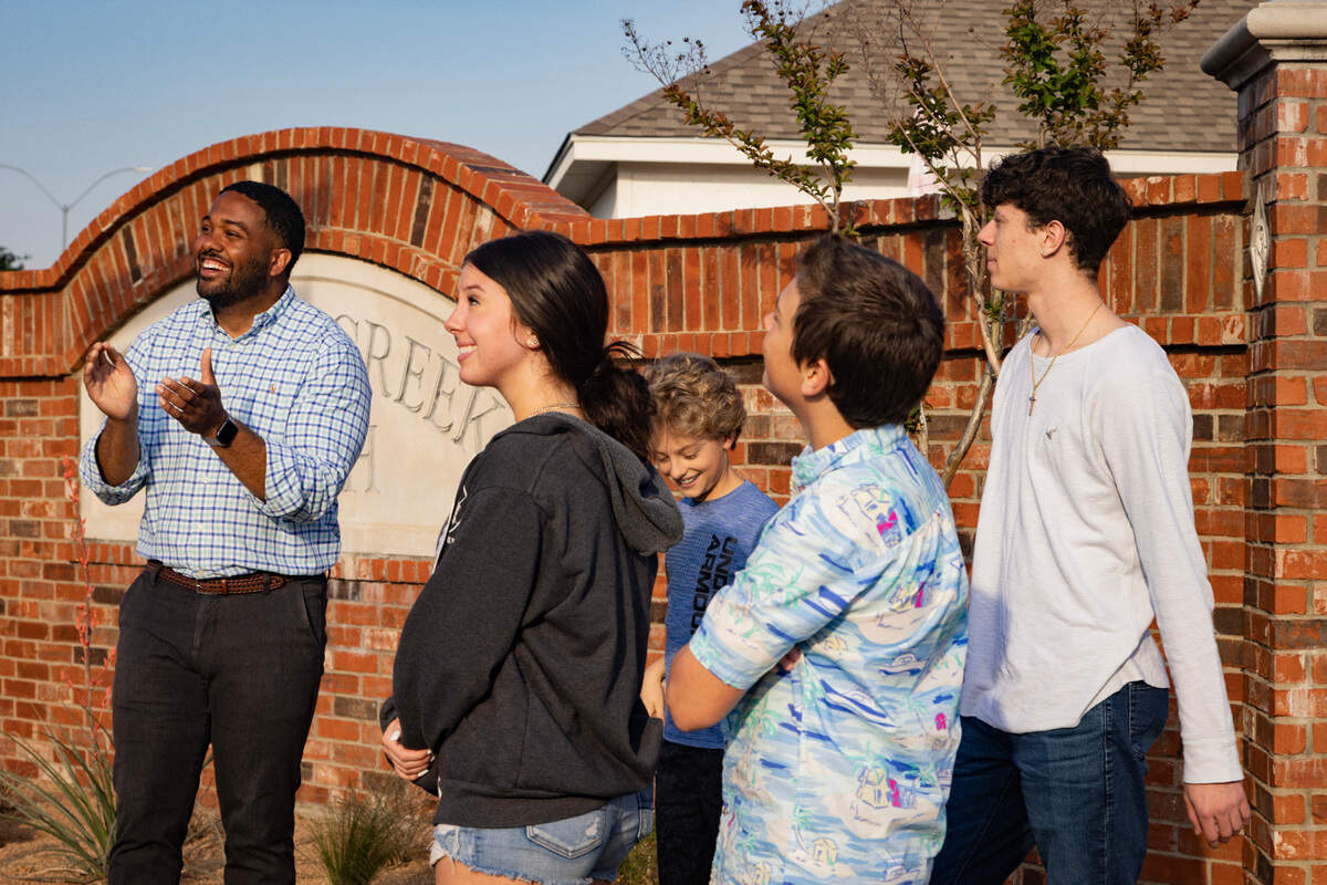 Councilman Jared Williams claps for Abigail, 16, Chris, 12, Micah, 14, and Wesley Arbour, 18 after unveiling a street sign dedicated to their parents in the Summer Creek Ranch neighborhood of Fort Worth on Wednesday, May 3, 2023. Meg and Ben Arbour were killed in a car accident caused by two vehicles racing at night in November 2020.