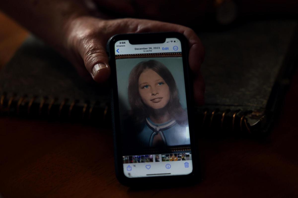 Rusty Arnold shows a photo of his sister, Rachel Trlica, that his mother keeps on her cellphone. Trlica went missing in 1974 with two other girls. The family has spent the last 50 years searching for her.