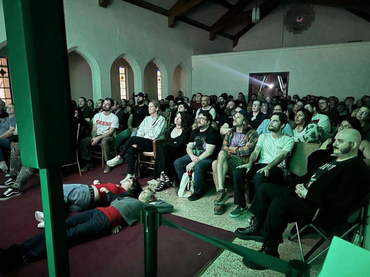 A crowd at Weird Wednesday watches a movie in Southside Preservation Hall’s Rose Chapel.