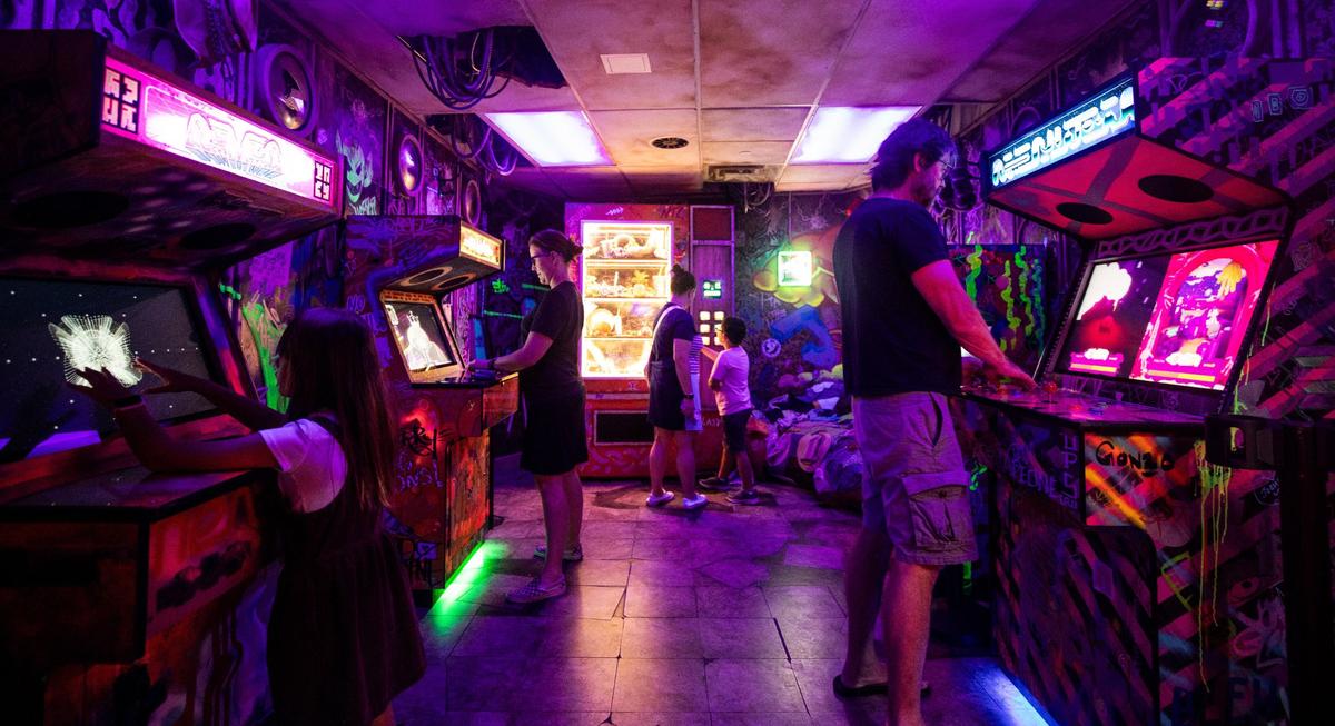Attendees play arcade games on Wednesday, June 12, 2004, at Meow Wolf in Grapevine. Meow Wolf offers various interactive attractions and artwork.