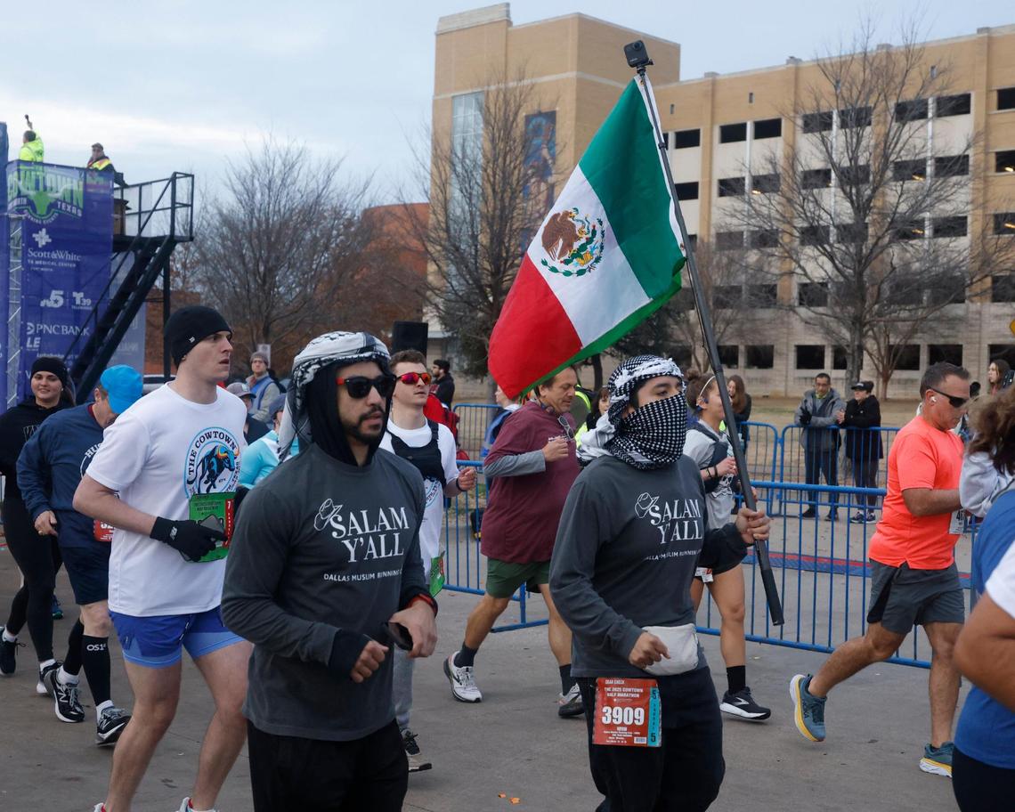 Kevin Mendez carries the flag for the Dallas Muslim Running Club during the 2025 Cowtown at the Will Rogers Memorial Center in Fort Worth, Texas, Sunday, Feb. 23, 2025.